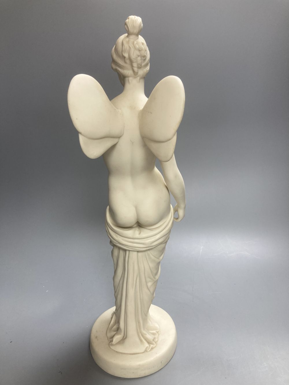 A Copeland Parian figure of a winged maiden and a later composition figure of Venus bathing, H 43cm